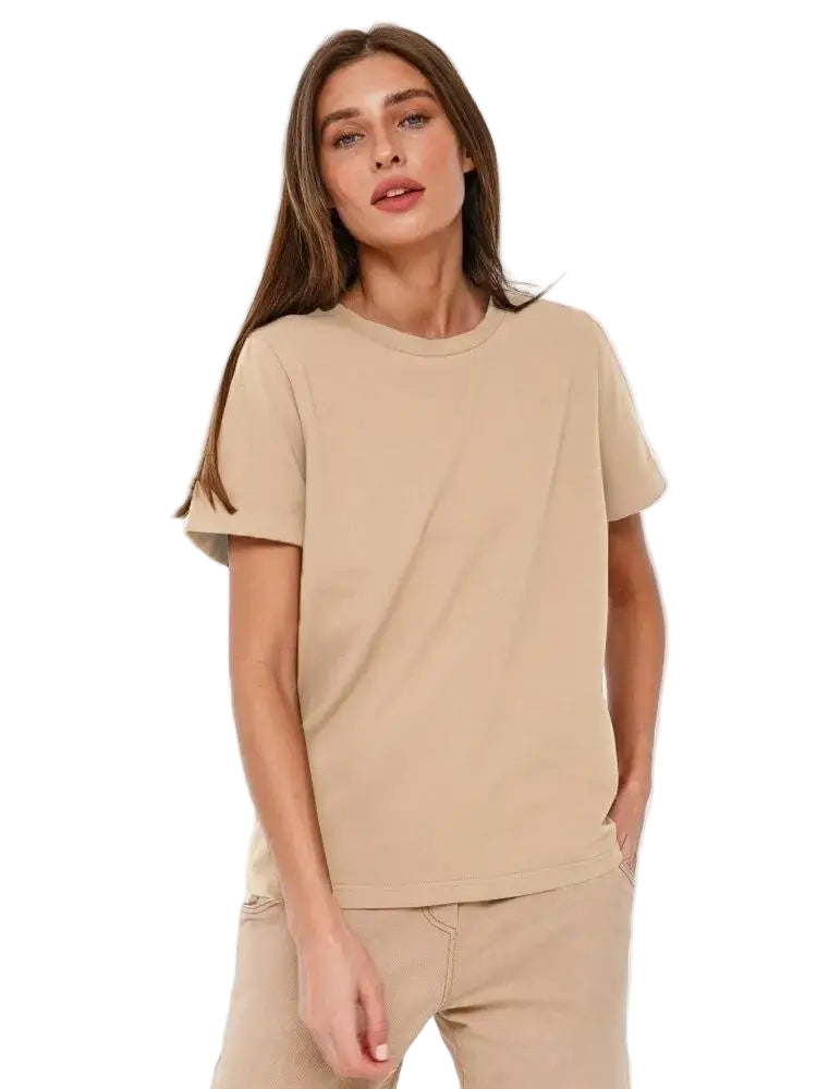 Woman wearing a beige t-shirt and pants on a white background