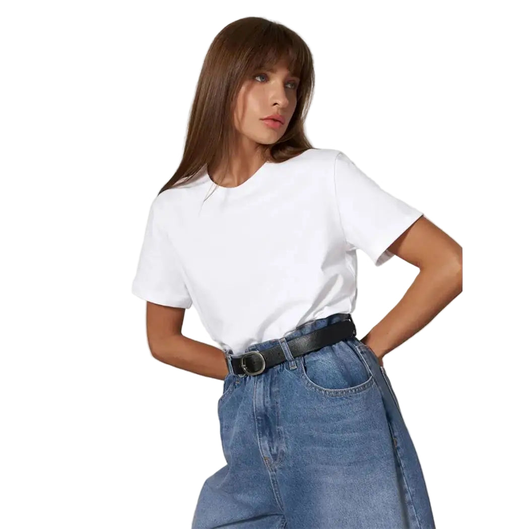 Woman wearing a white t-shirt and blue jeans against a plain background