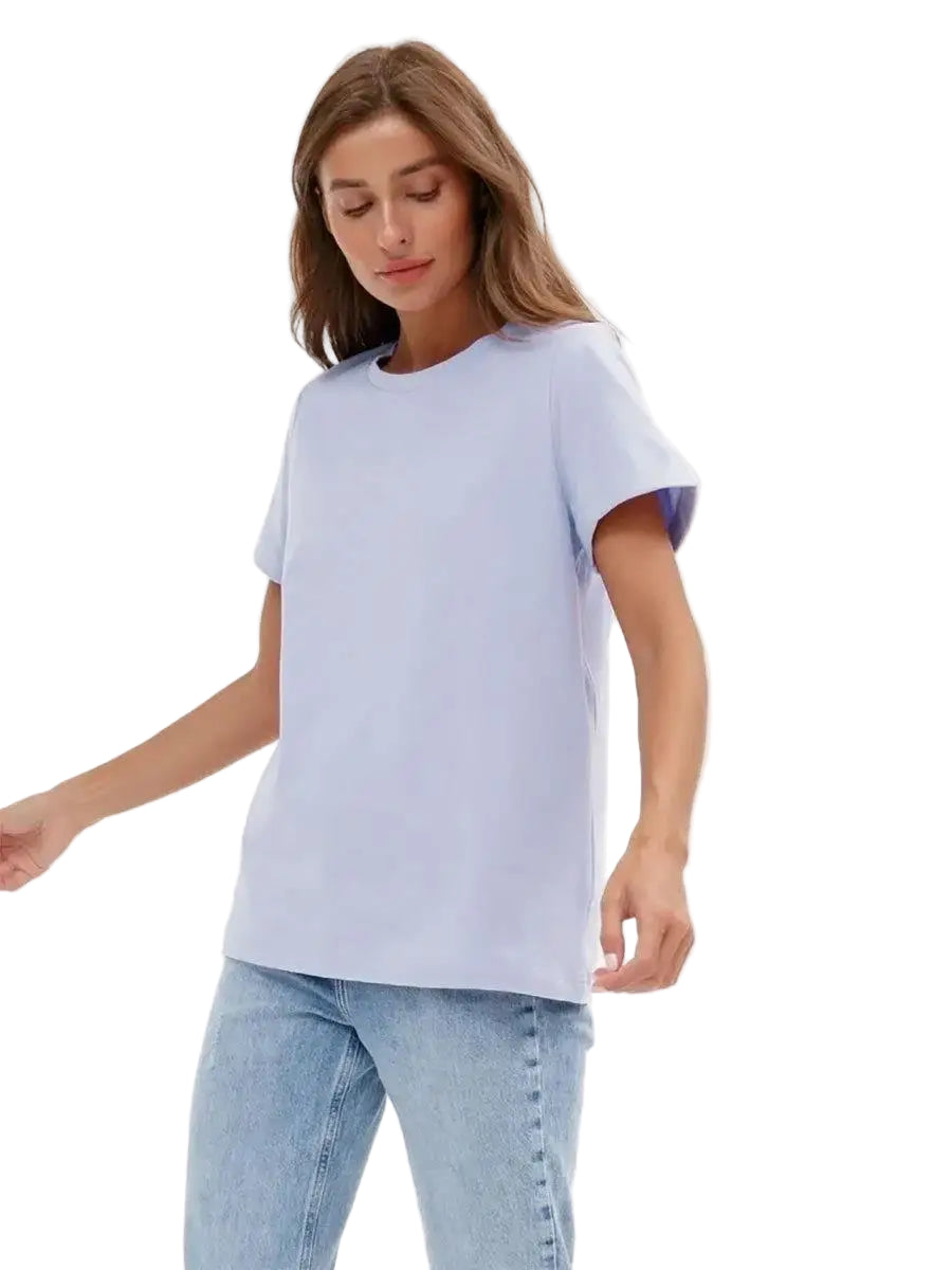 Woman wearing a light blue t-shirt and jeans on a white background