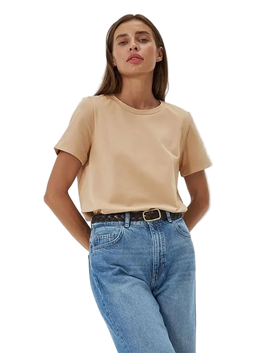 Woman wearing a beige t-shirt and blue jeans on a white background