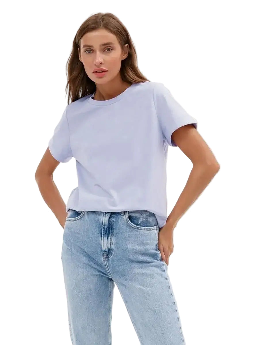 Woman wearing a light blue t-shirt and jeans on a white background