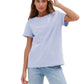Woman wearing a light blue t-shirt and jeans on a white background