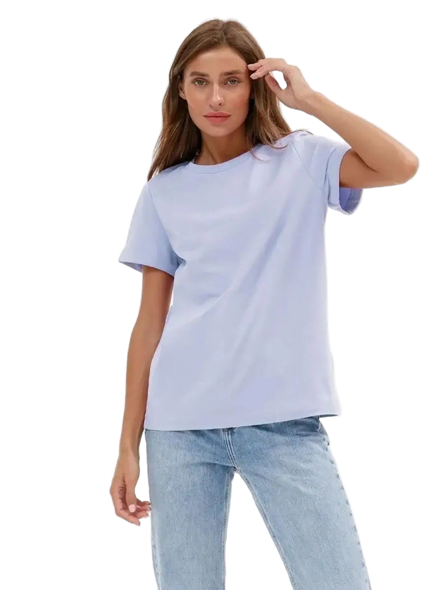Woman wearing a light blue t-shirt and jeans on a white background