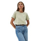 Woman wearing a light green t-shirt and blue jeans on a white background