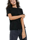 Woman wearing a black t-shirt and dark jeans on a white background