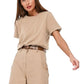 Woman wearing a beige t-shirt and pants with a belt on a white background