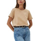 Woman wearing a beige t-shirt and blue jeans on a white background