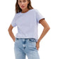 Woman wearing a light blue t-shirt and jeans on a white background